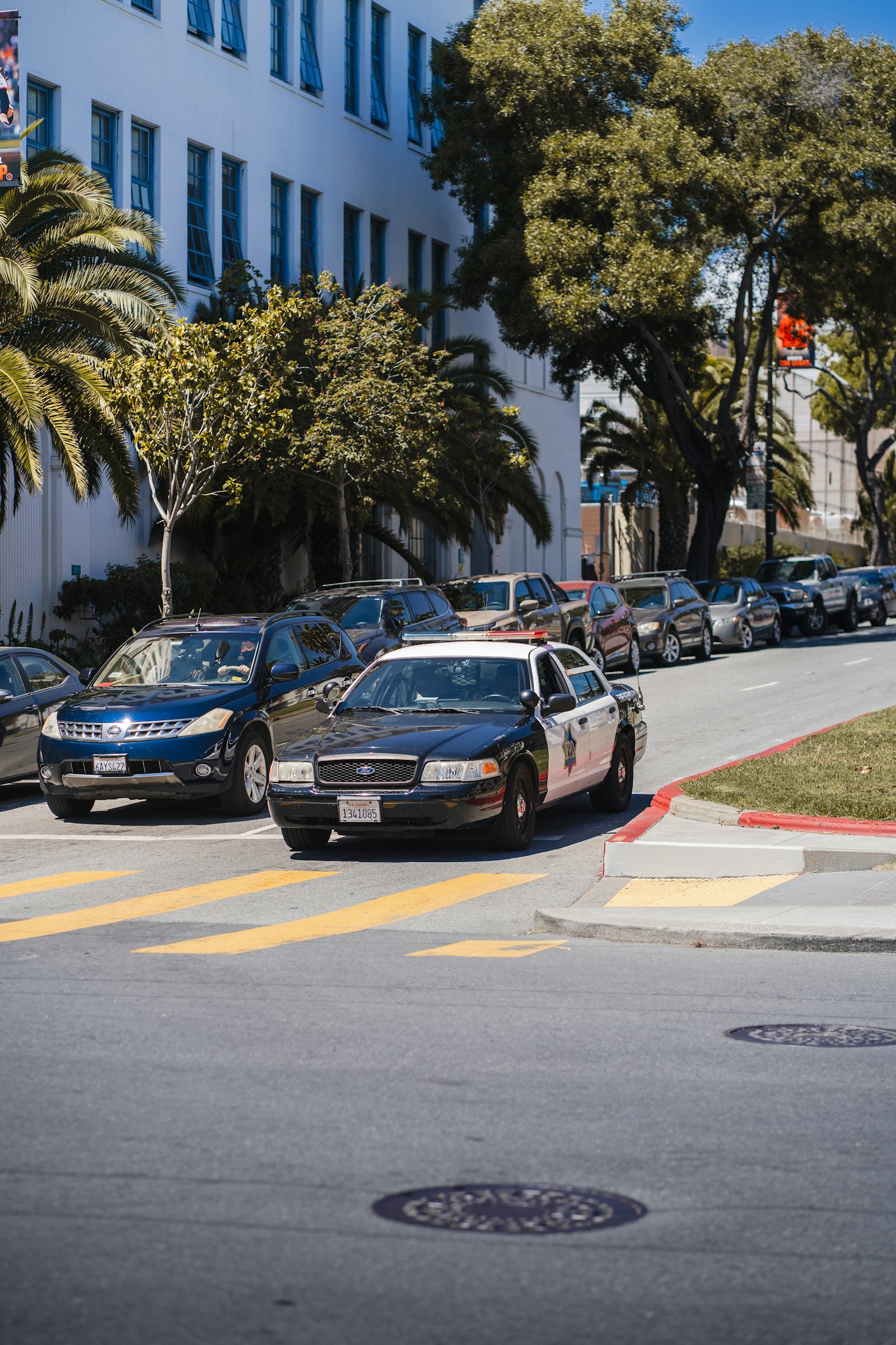 Police car driving down a city street